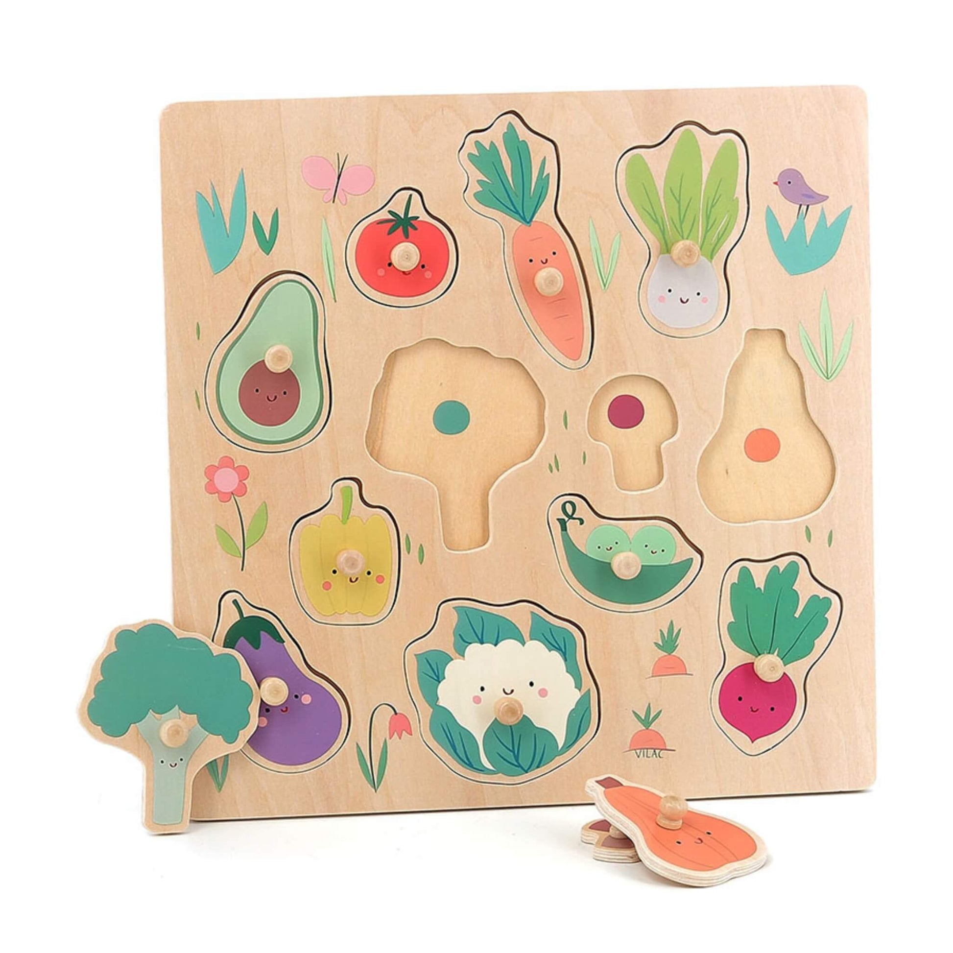 Wooden toddler puzzle with vegetable peg pieces partly removed, showing colour-coded guides beneath each slot.