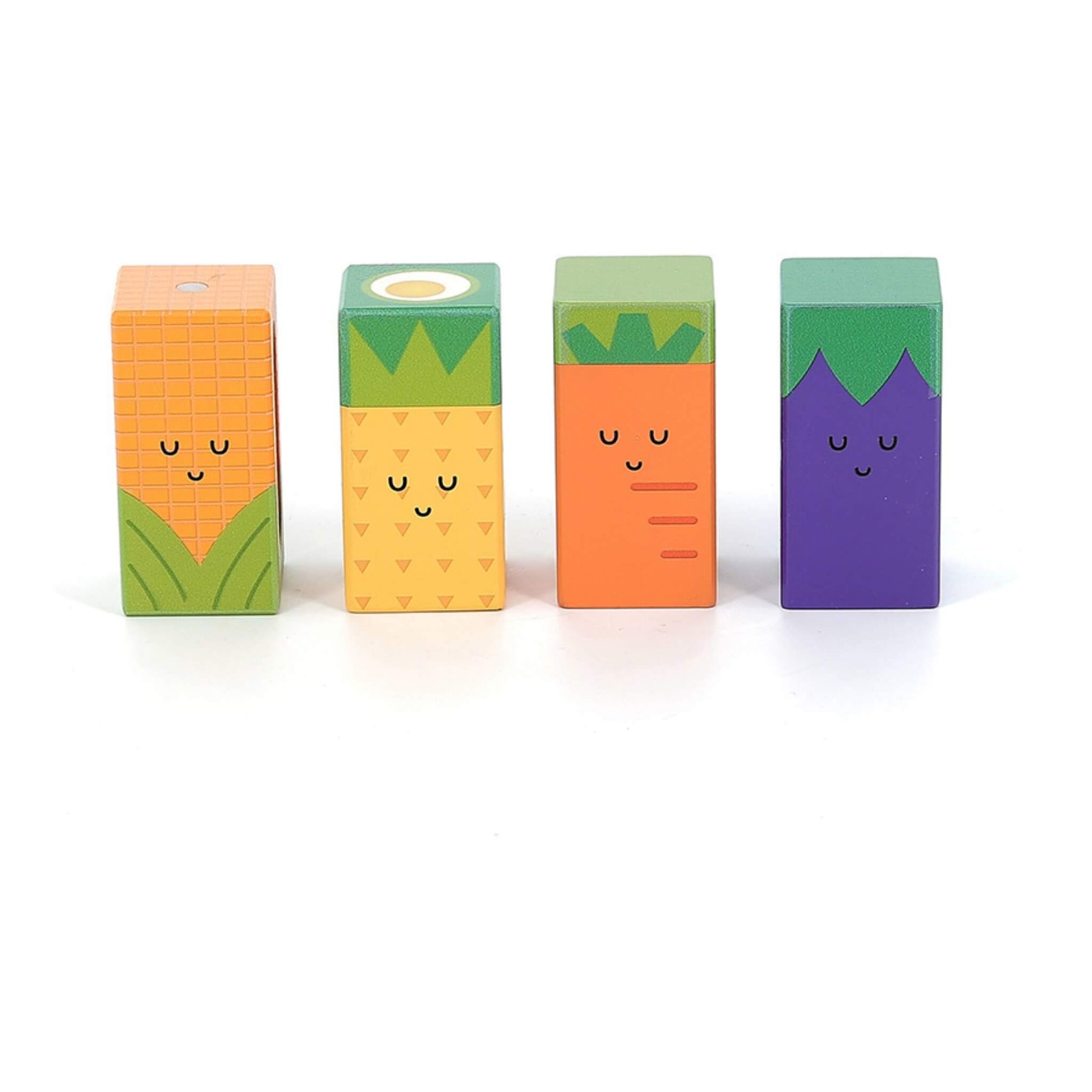 Four rectangular wooden blocks painted as corn, pineapple, carrot, and aubergine with smiling faces, standing upright in a row on a white background.