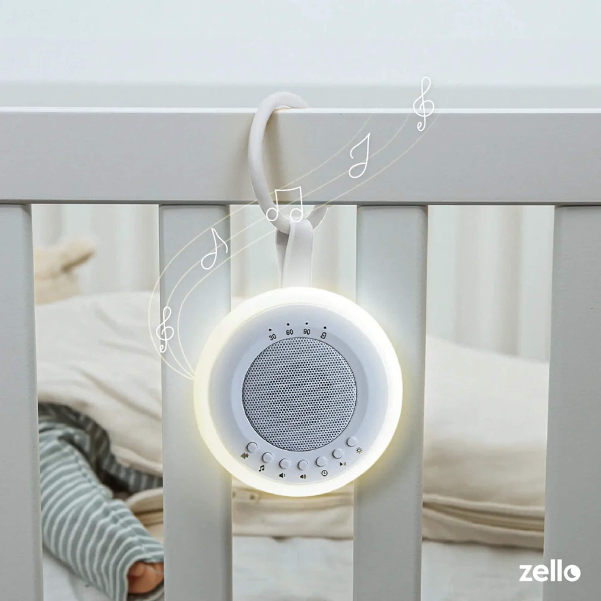 Baby white noise machine with soft night light clipped onto cot rail, illustrated with music notes to show soothing sound for infant sleep.