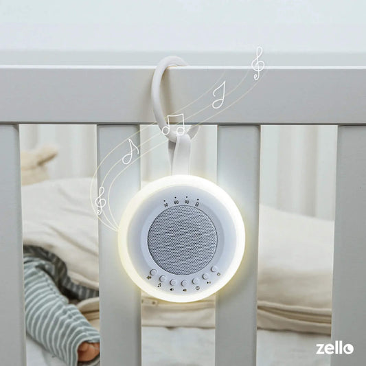 Baby white noise machine with soft night light clipped onto cot rail, illustrated with music notes to show soothing sound for infant sleep.