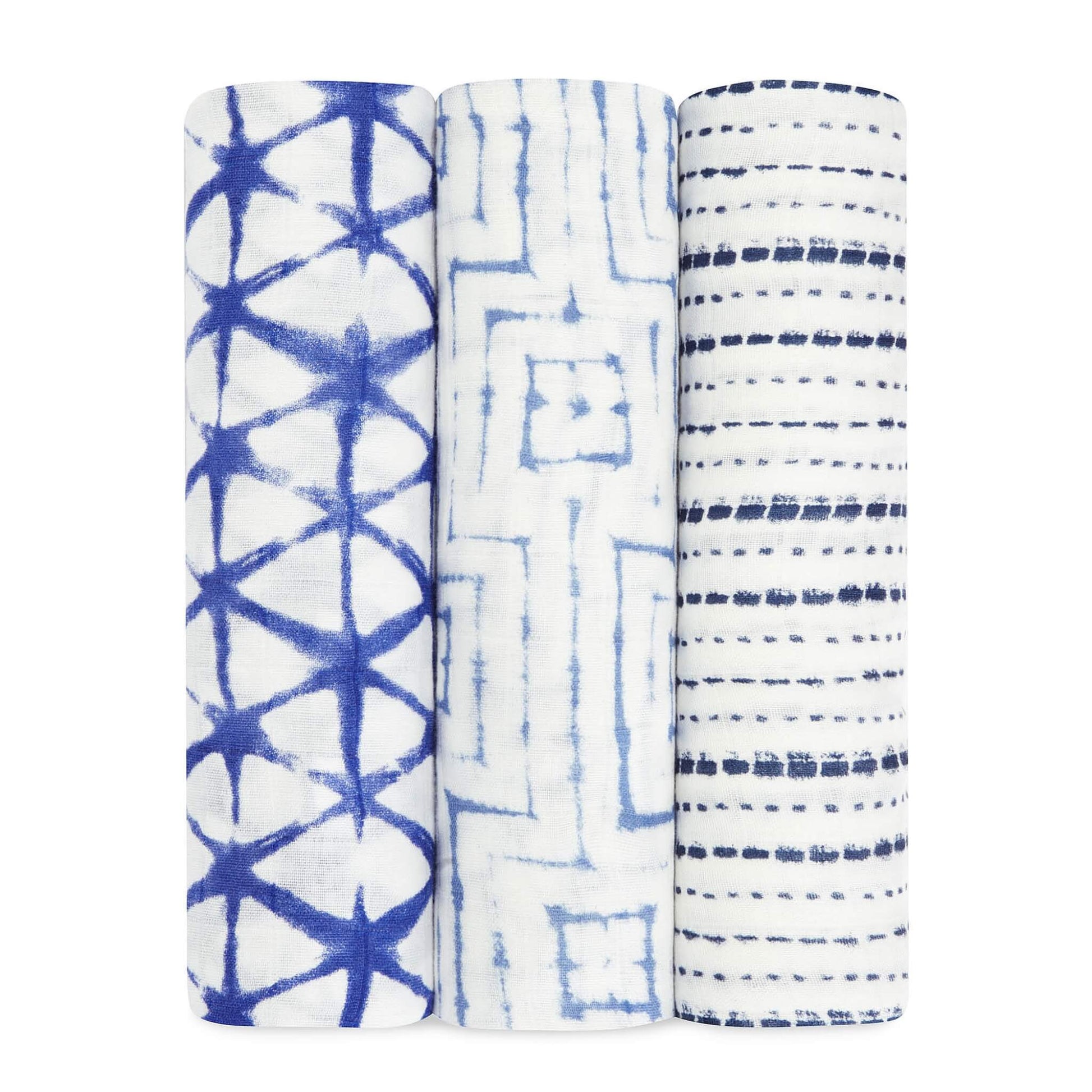 Aden + Anais Silky Soft Swaddles 3-Pack in Indigo, showing three rolled swaddles with tie-dye style geometric patterns in shades of deep blue and white.