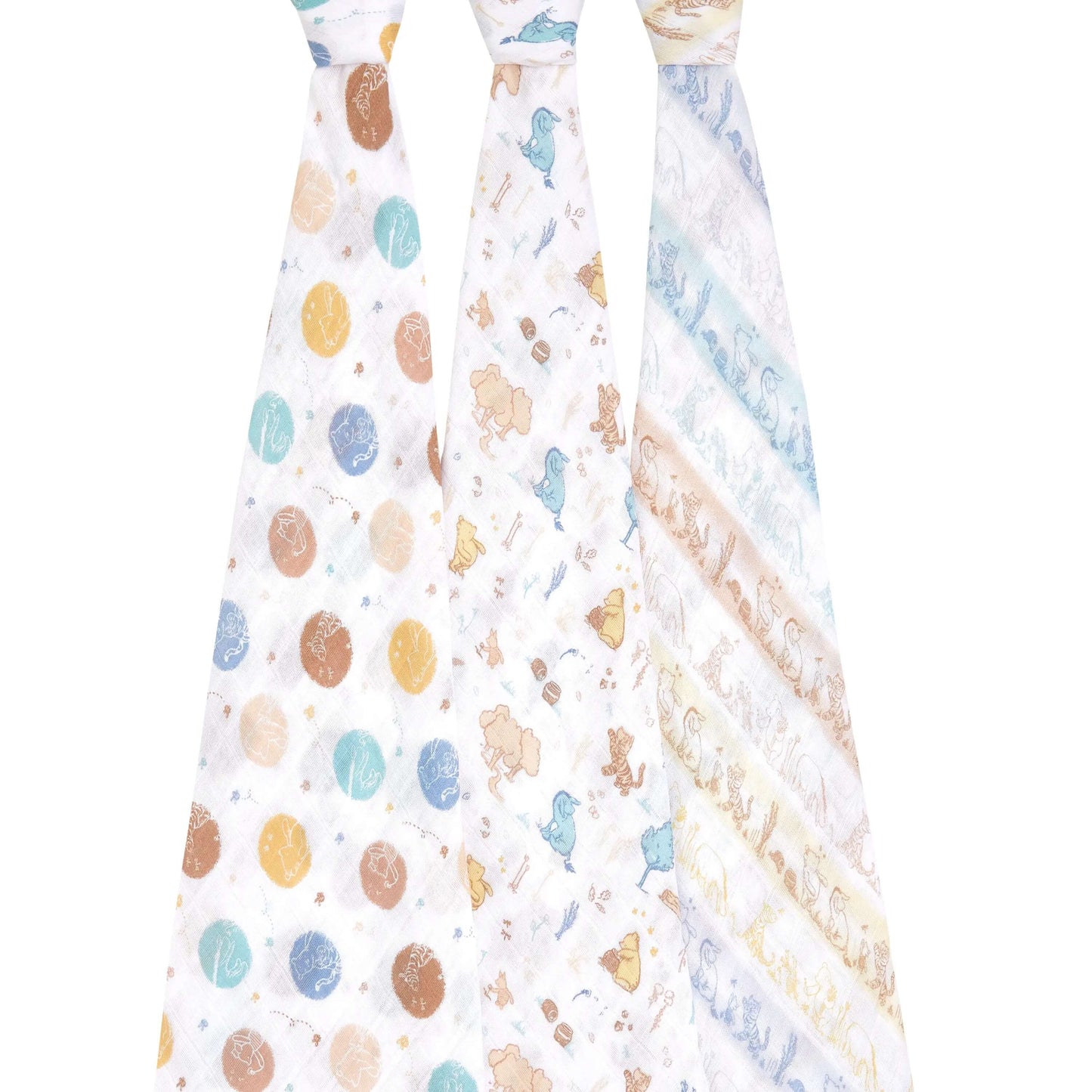 Three aden + anais cotton muslin swaddles hanging to show full Winnie the Pooh and forest-themed prints in soft greens, browns, and blues.