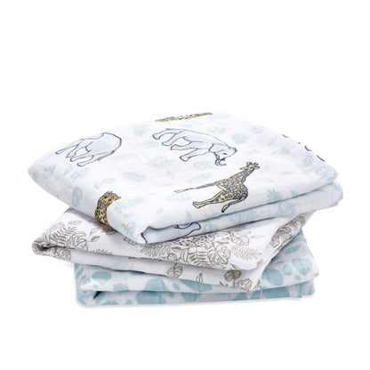 Stack of three cotton muslin squares with jungle-themed animal prints in soft blue, gold and neutral tones.