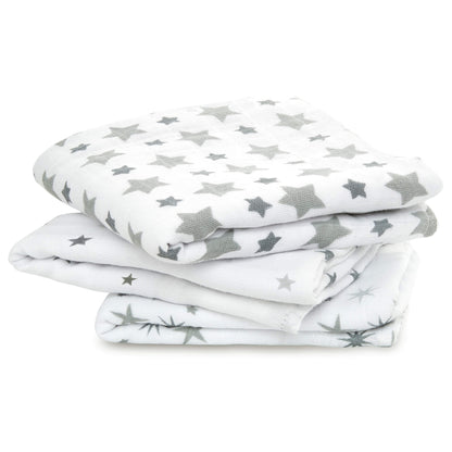 Stack of three white cotton muslin squares with grey star prints from the aden + anais Twinkle collection.
