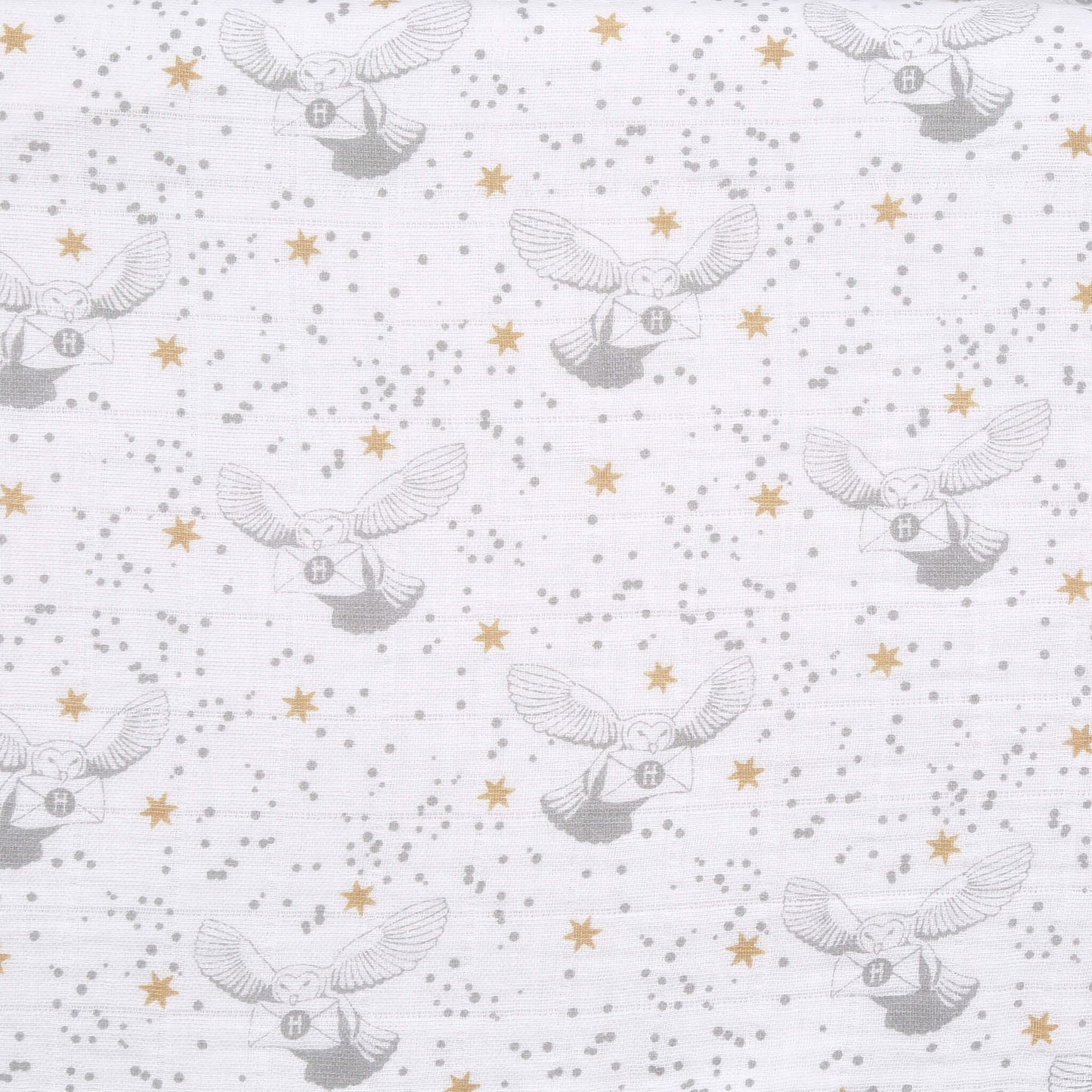 Detailed fabric swatch of aden + anais Harry Potter™ muslin with grey Hedwig owls carrying letters, gold stars, and grey speckles on white background.