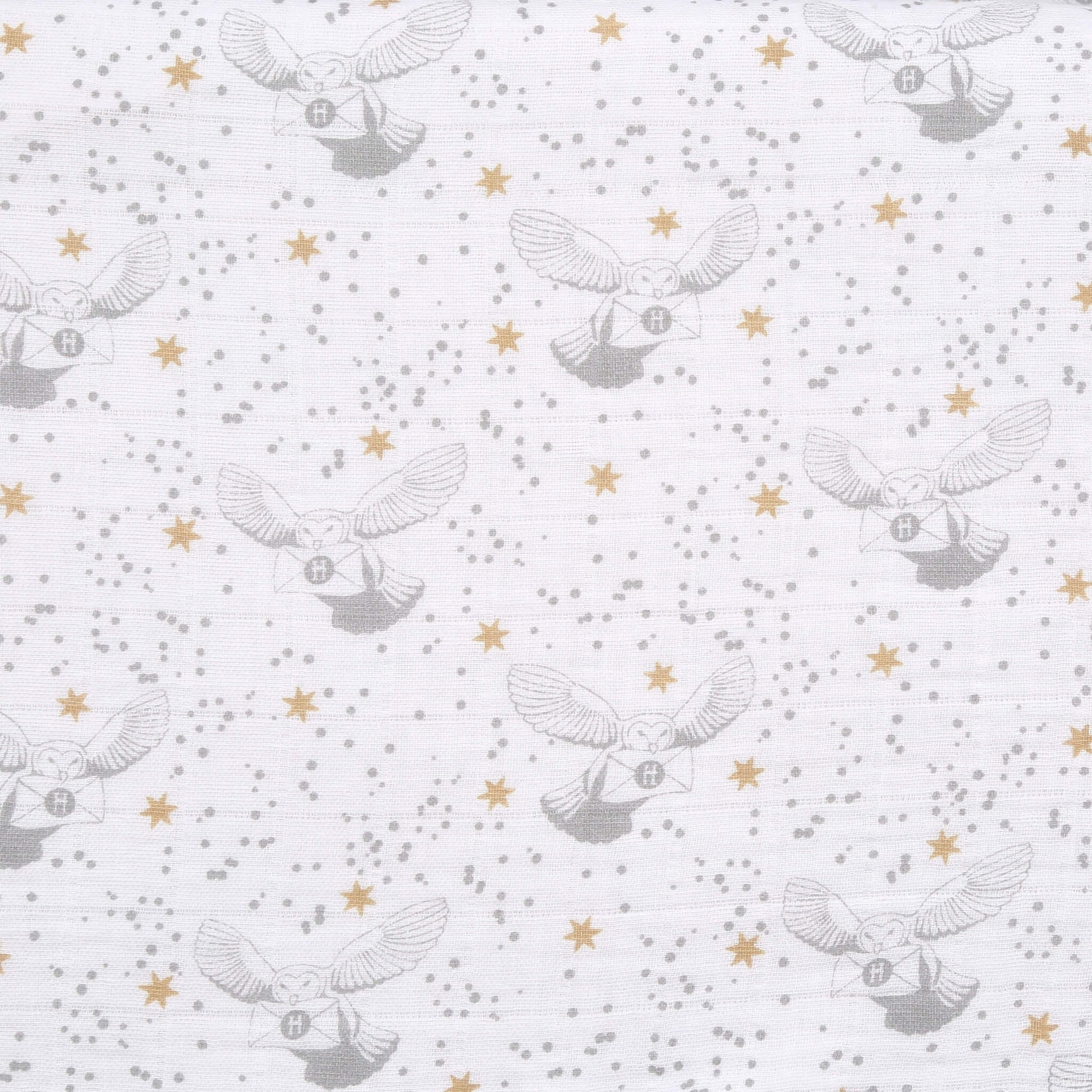 Detailed fabric swatch of aden + anais Harry Potter™ muslin with grey Hedwig owls carrying letters, gold stars, and grey speckles on white background.