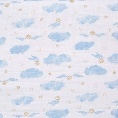 Close-up fabric swatch of the aden + anais Harry Potter™ muslin featuring blue clouds and golden snitch motifs on white background.