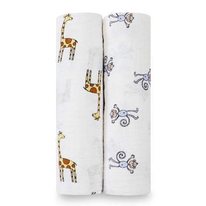 Rolled aden + anais Jungle Jam swaddles featuring cheerful giraffe and monkey prints on soft, breathable cotton muslin.