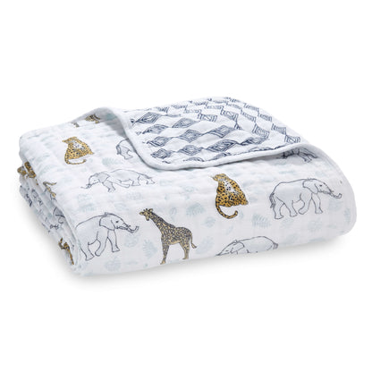 Taden + anais Dream Blanket in breathable cotton muslin, featuring a jungle animal print with elephants, giraffes, and cheetahs on a soft white base.