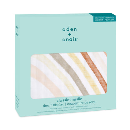 Boxed aden + anais cotton muslin Dream Blanket with a soft rainbow print in muted orange, yellow, and taupe tones on a white background.