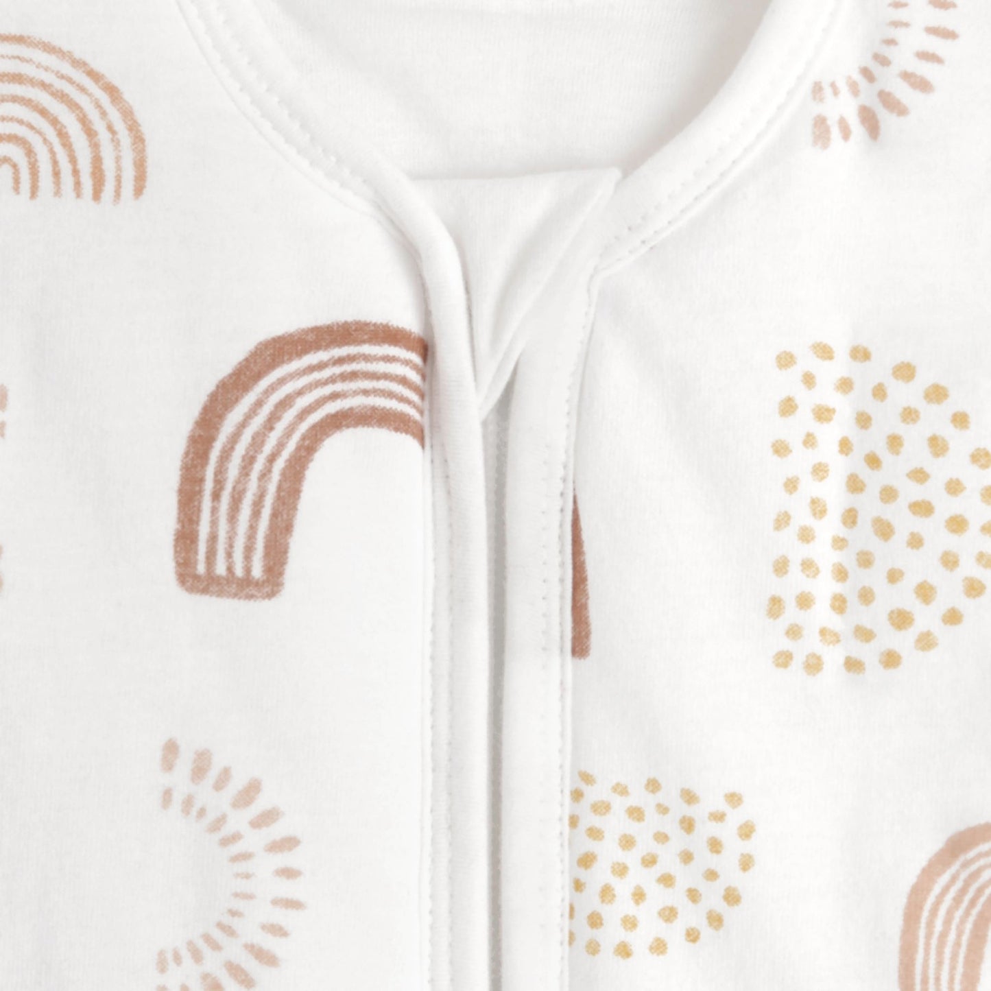 Close-up of aden + anais sleeping bag zip cover and neckline in Keep Rising rainbow print. Soft 100% cotton and detailed finish.