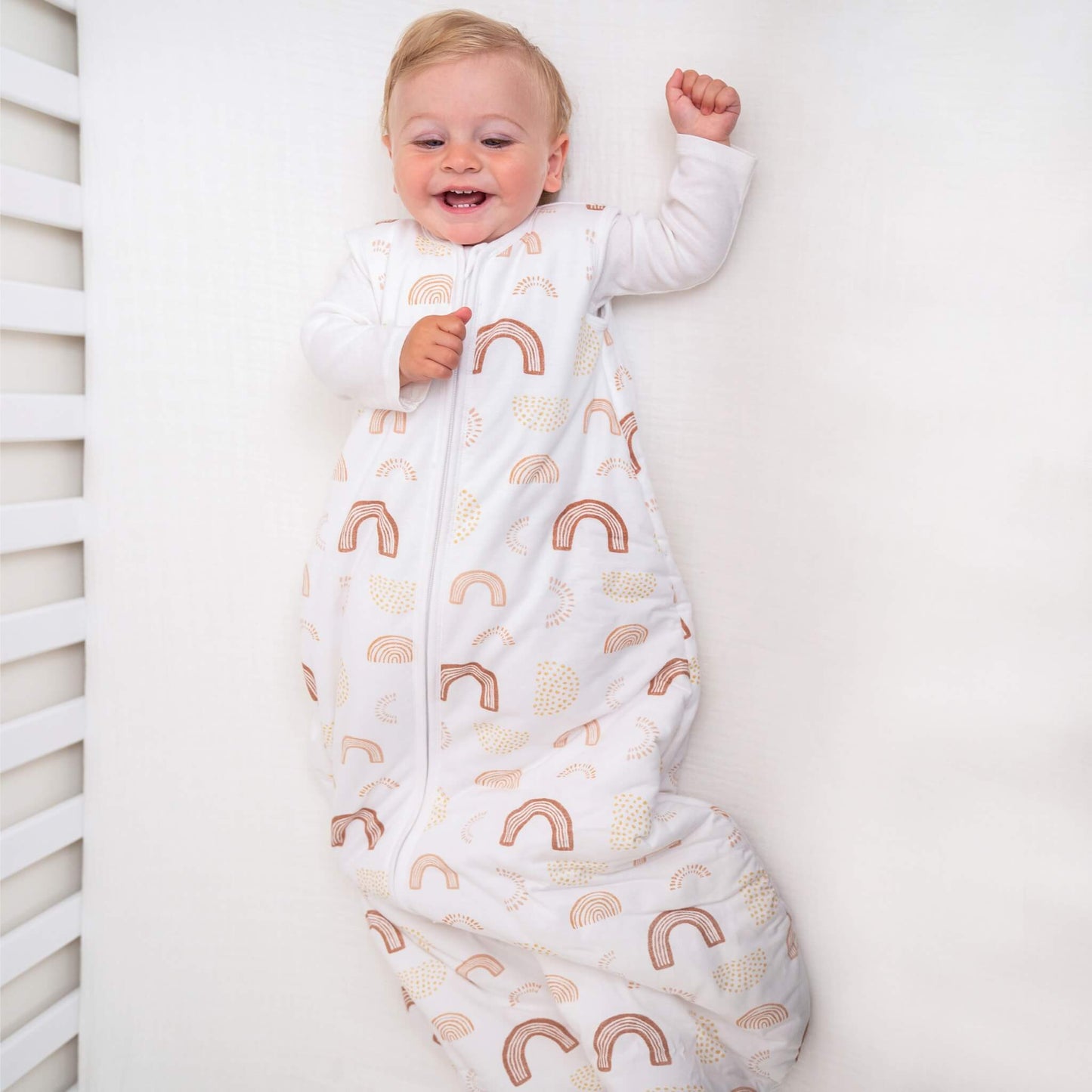 Smiling toddler wearing aden + anais Keep Rising winter sleeping bag. Cosy, wearable blanket with warm cotton fill for colder nights.