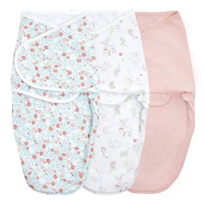 Three aden + anais Easy Wrap Swaddles in Fairy Tale Flowers prints, folded and stacked side by side.