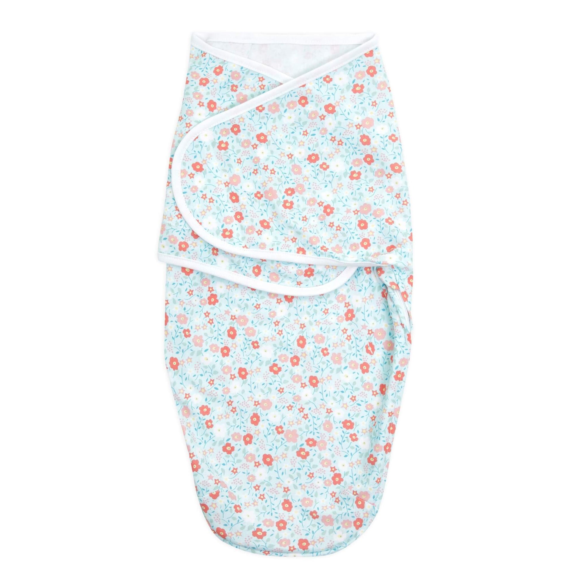 aden + anais swaddle wrap with light blue floral print and white trim, folded and secured.