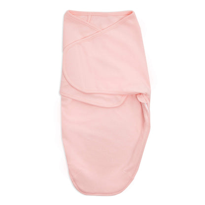 Solid blush pink aden + anais cotton swaddle wrap, folded with hook-and-loop fastener visible.