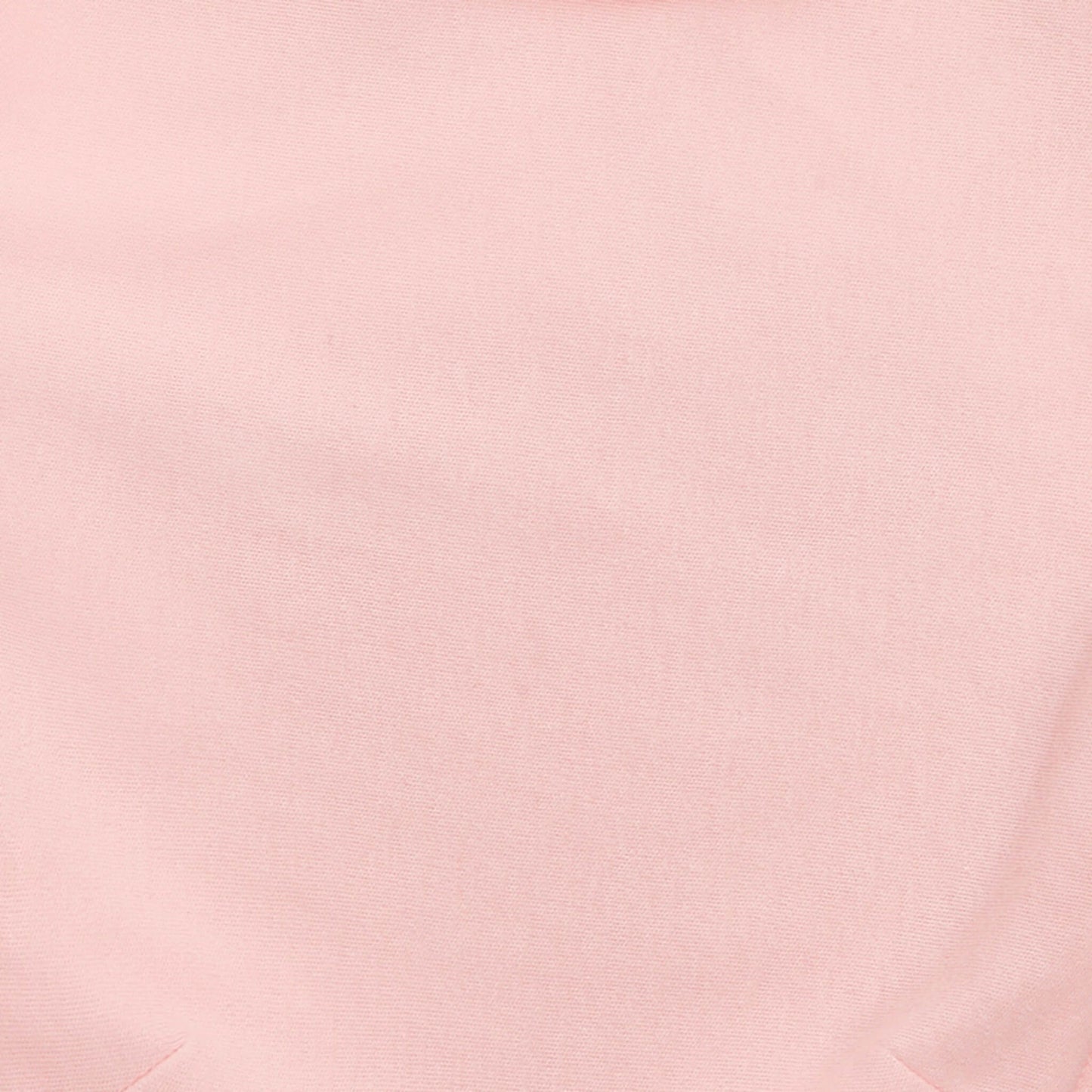Close-up of soft solid pink aden + anais cotton swaddle fabric.