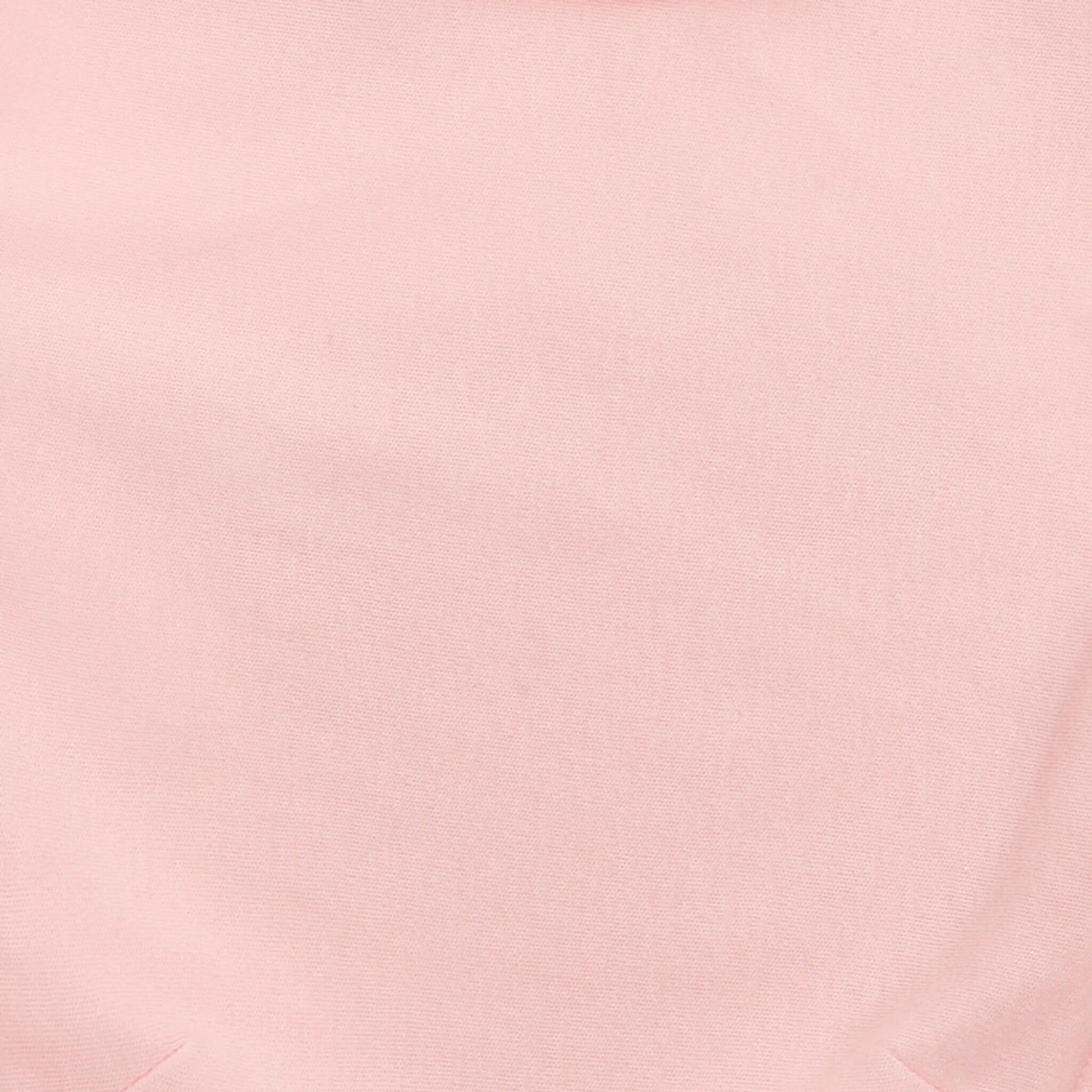 Close-up of soft solid pink aden + anais cotton swaddle fabric.