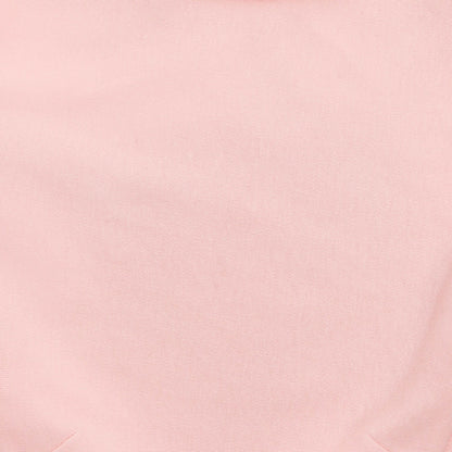 Close-up of soft solid pink aden + anais cotton swaddle fabric.