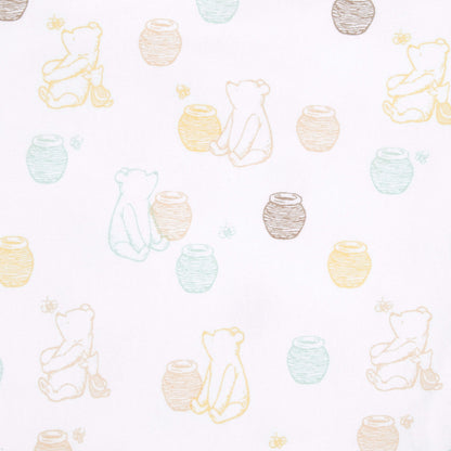 A detailed close-up of white fabric with sketch-style Winnie the Pooh figures sitting next to yellow, brown, green, and blue honey pots, with bees scattered throughout.