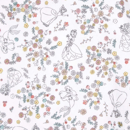 A close-up of the white swaddle fabric featuring fine line drawings of princesses such as Ariel and Tiana scattered among clusters of pastel flowers.