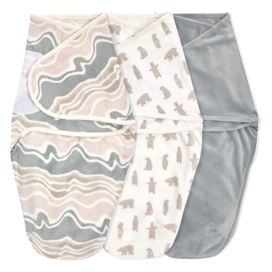 Three velboa swaddle wraps in the Little Woods design, laid flat to show patterns.