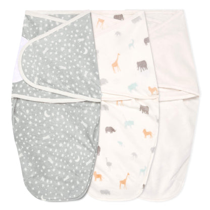 Flat lay of three velboa swaddles in Wild Prairie design with moonlit grey, safari animals, and solid cream styles.