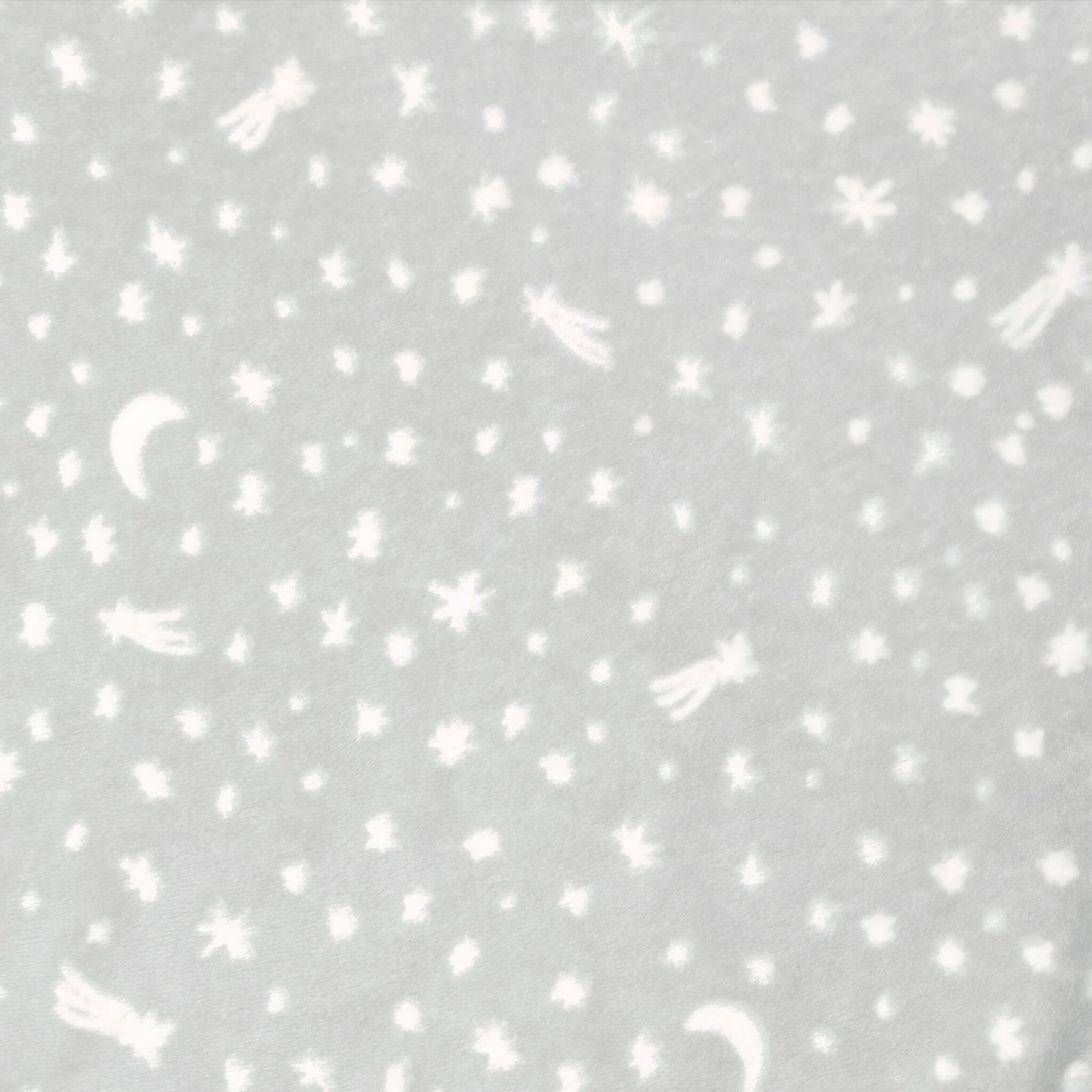 Close-up of grey swaddle fabric with moons, stars, and comets in white.