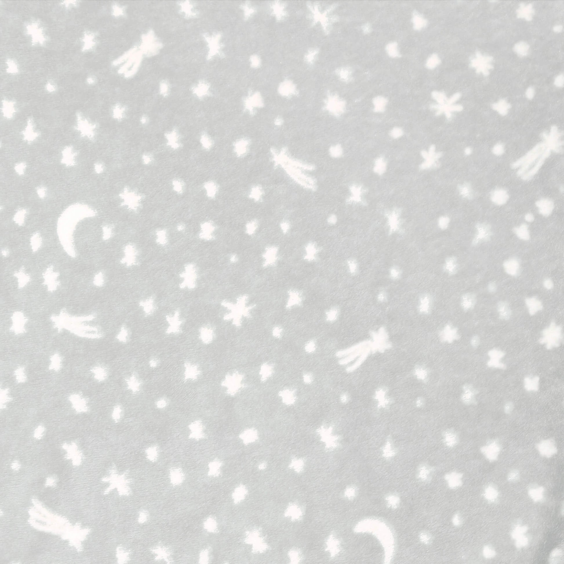 Close-up of grey swaddle fabric with moons, stars, and comets in white.
