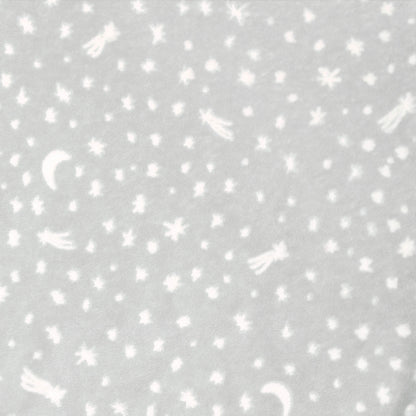 Close-up of grey swaddle fabric with moons, stars, and comets in white.