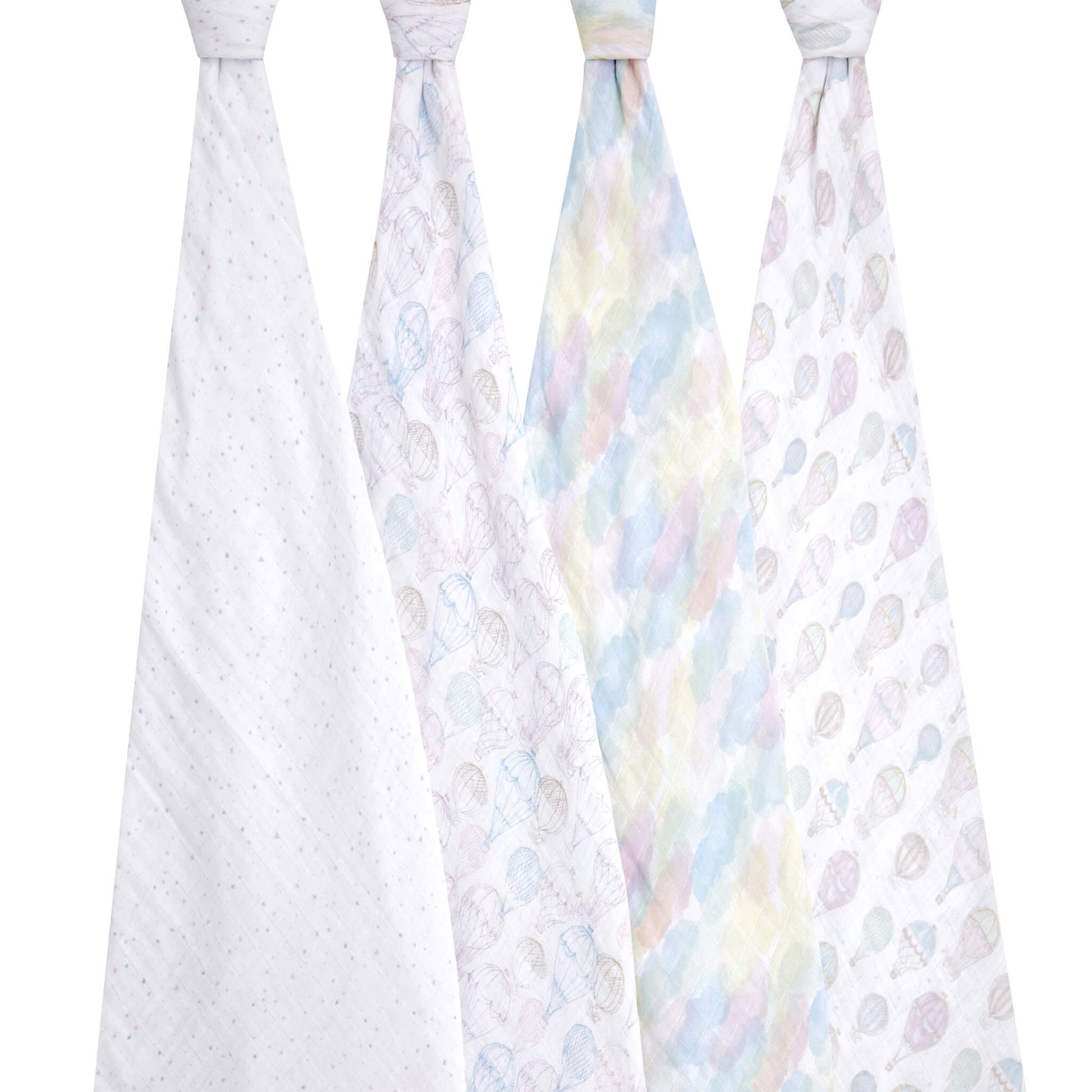 Four aden + anais organic cotton muslin swaddles displayed hanging, featuring pastel cloud and hot air balloon patterns. Breathable, lightweight, and gentle for baby.