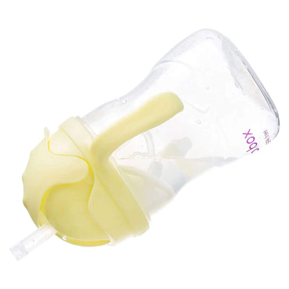 A clear sippy cup with a yellow lid and handles shown tilted on its side, displaying the internal weighted straw.