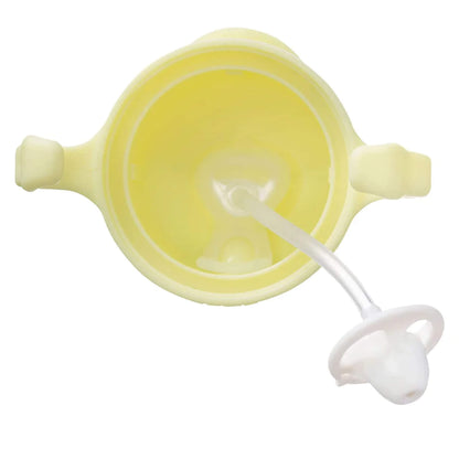A close-up view of the underside of a yellow sippy cup’s lid showing the silicone weighted straw extending through the centre of the lid.