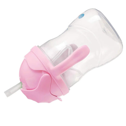 A clear sippy cup with a pink lid and handles shown tilted on its side, displaying the internal weighted straw.