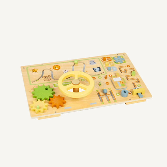 Wooden sensory activity board with a steering wheel, sliding maze track, rotating gears, pretend phone and lock-and-key activity arranged across a pale wood panel.