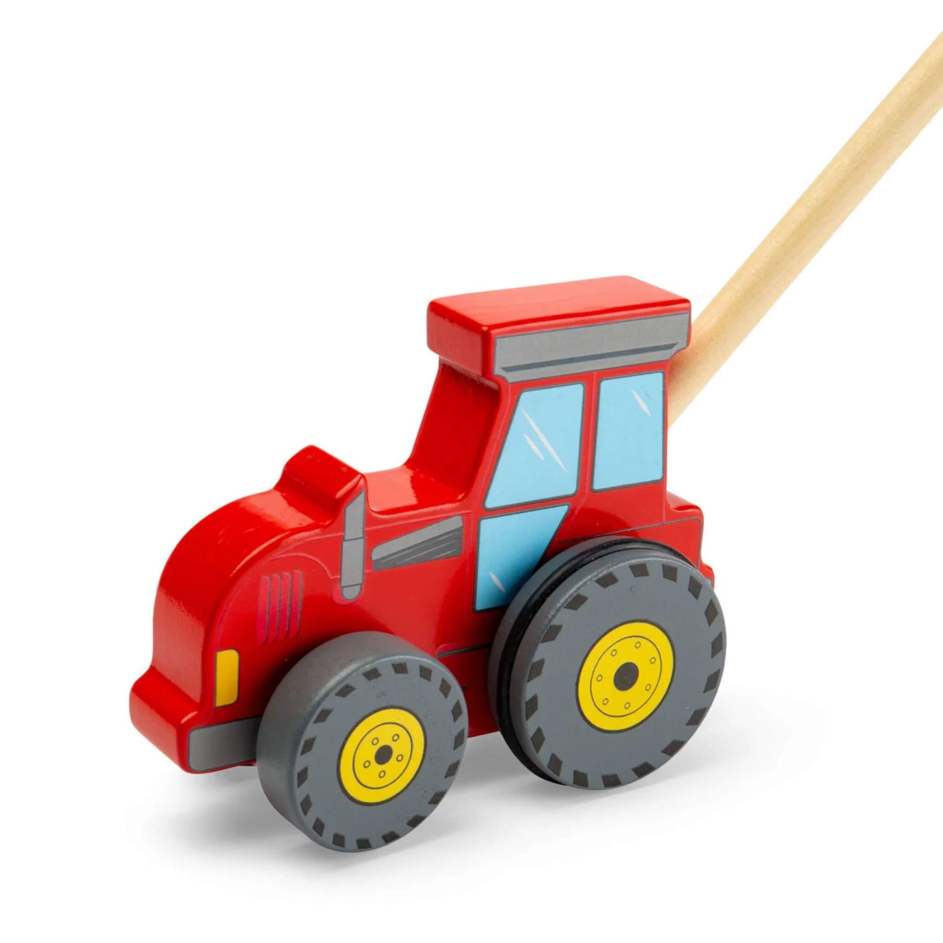 Bigjigs Toys Tractor Push Along shown as a red wooden tractor with blue windows, grey detailing, chunky grey wheels with yellow centres and a natural wood handle attached.