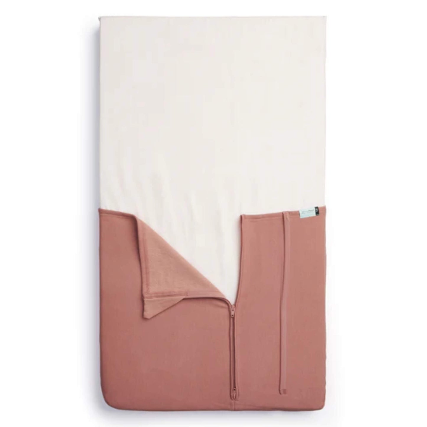 Top-view of the HugMe Blanket in rose laid to fit the mattress, with the zip partially open to display its fitted sleeve design.