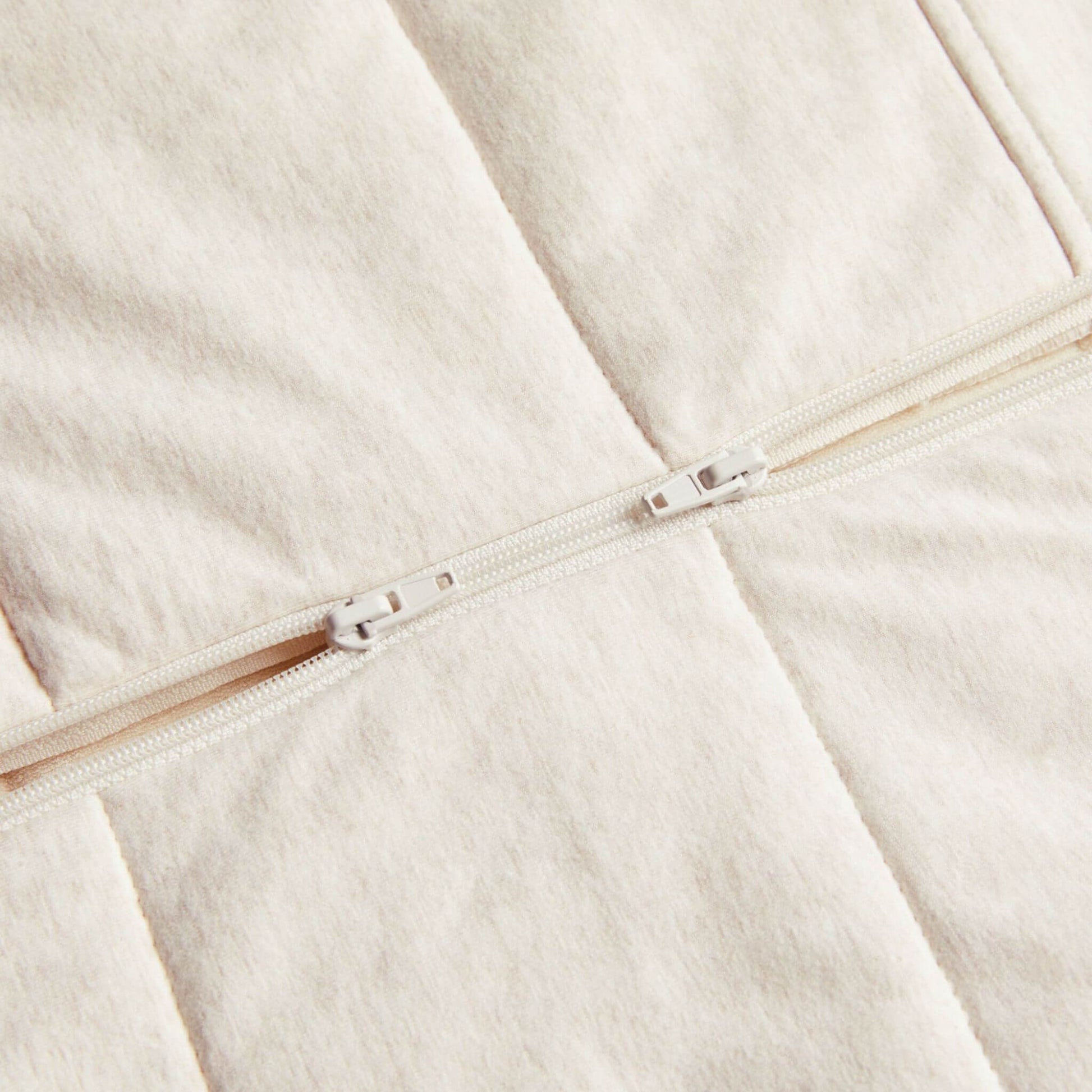Close-up of the ErgoPouch Winter Sleeping Bag in Oatmeal, highlighting the two-way zip for easy nappy changes.