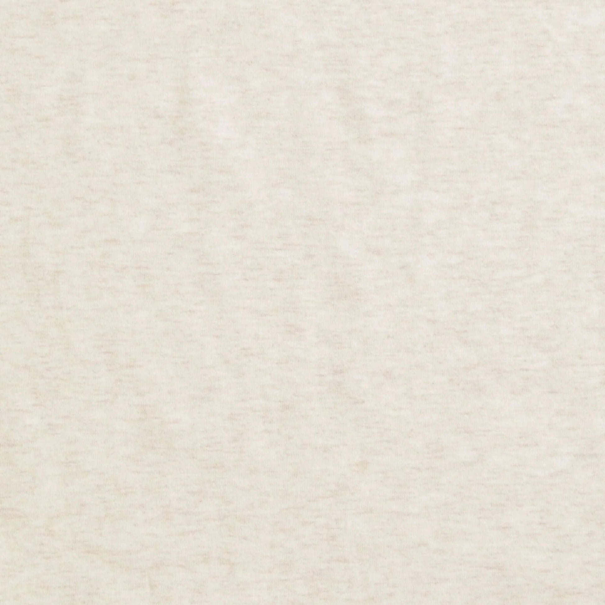 Close-up of plain oatmeal-coloured fabric showing a soft, heathered texture.