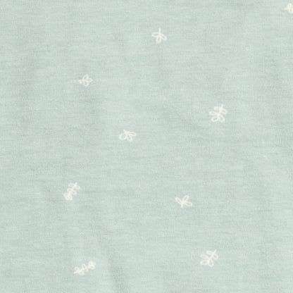 Close-up of pale sage green fabric with a scattered white line-drawn insect pattern.