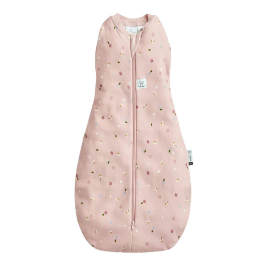 Ergopouch Summer Cocoon Swaddle Bag in the Daisies print shown flat with a pink background and a zip running down the front.