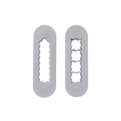 Pewter grey ezpz Food Cutters baby-led weaning prep tools with strip cutter for 6m+ foods and cube cutter for 9m+ foods.