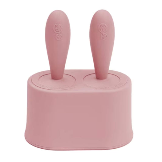Blush pink ezpz Tiny Pops baby popsicle mould with two short round handles designed for infant feeding and baby-led weaning.