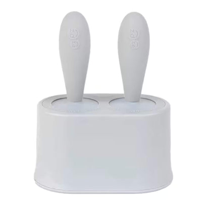 Ezpz Tiny Pops silicone baby popsicle mould set with two handles inserted into compact freezer stand designed for baby-led weaning portions.