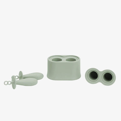Silicone baby popsicle mould components showing freezer base, lids and feeding handles arranged to display all parts.