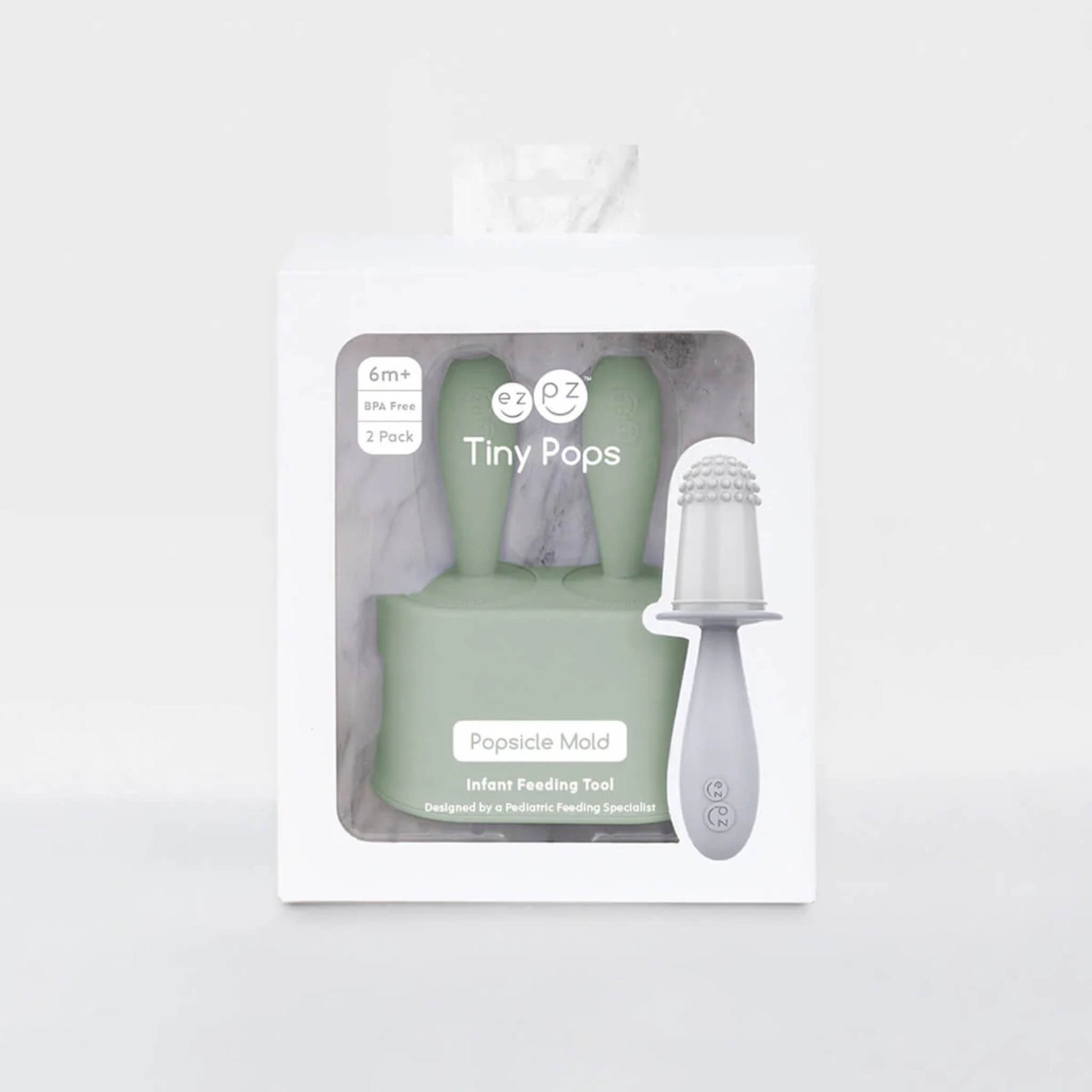 Retail packaging displaying baby popsicle mould set with two silicone handles and freezer base visible through front window.