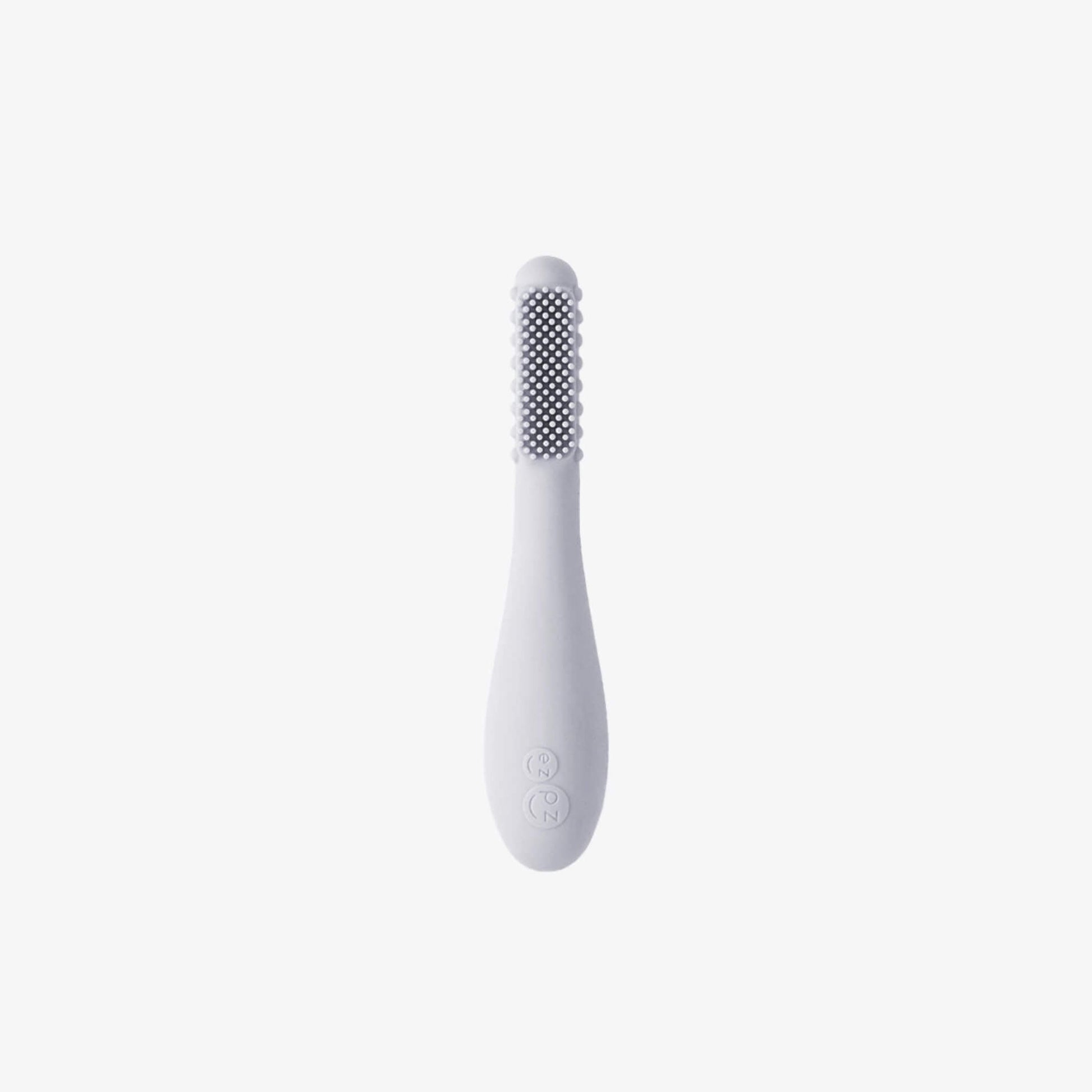 Ezpz Baby-Led Toothbrush in pewter grey made from soft silicone with textured sensory bumps and gentle bristles designed for babies learning early oral care.