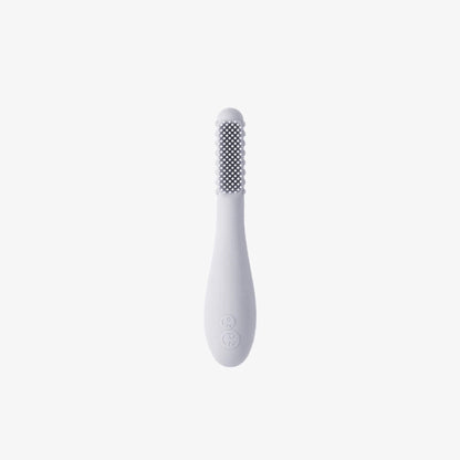 Ezpz Baby-Led Toothbrush in pewter grey made from soft silicone with textured sensory bumps and gentle bristles designed for babies learning early oral care.
