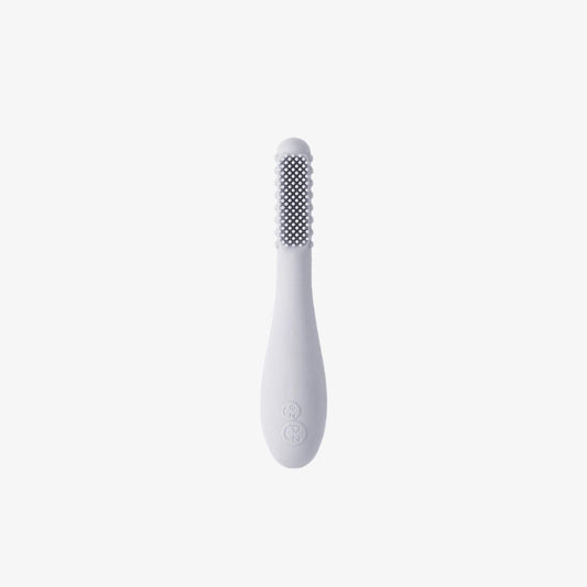 Ezpz Baby-Led Toothbrush in pewter grey made from soft silicone with textured sensory bumps and gentle bristles designed for babies learning early oral care.