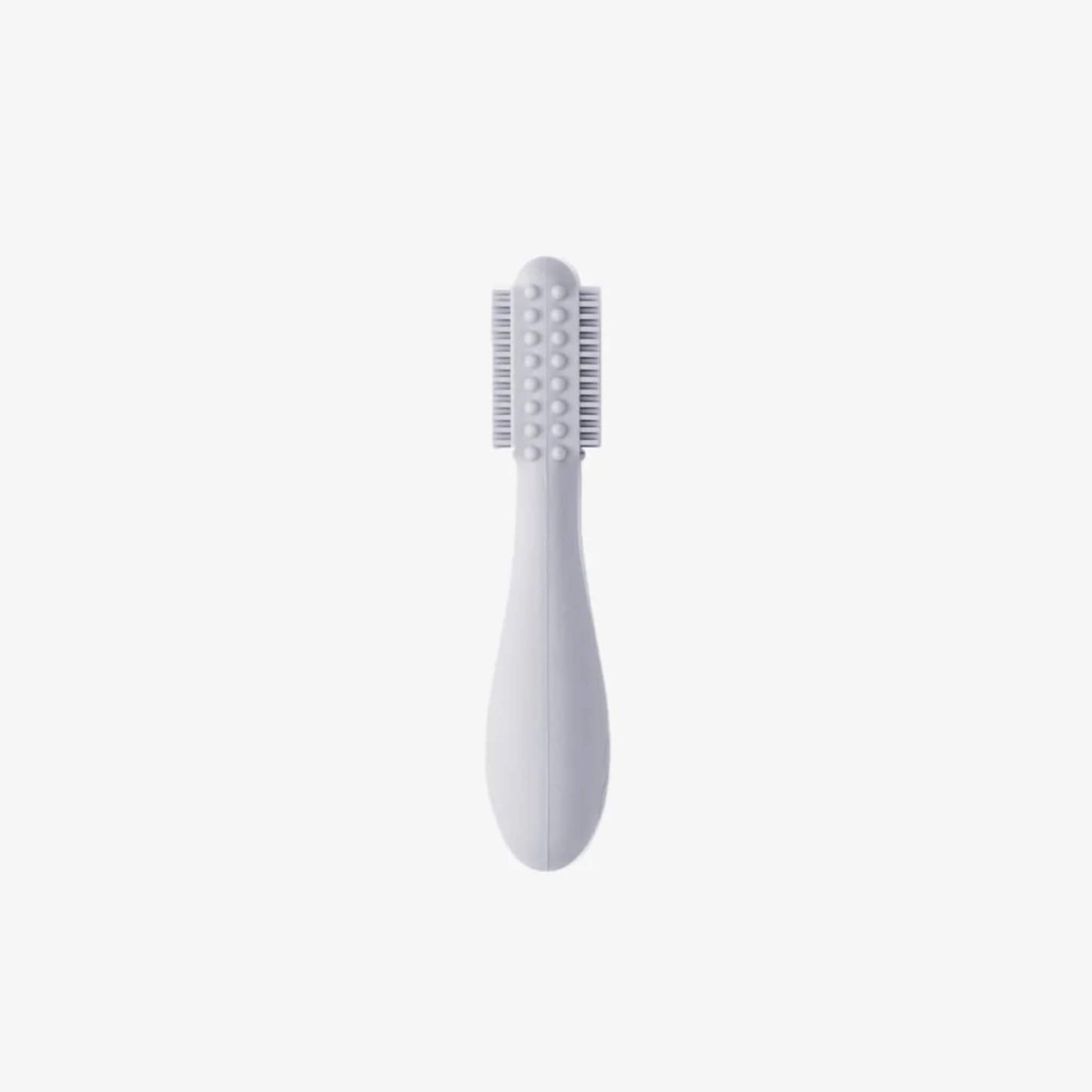 Grey silicone baby toothbrush showing soft bristles on both sides with raised sensory bumps along a rounded head and a thick easy-grip handle for small hands.