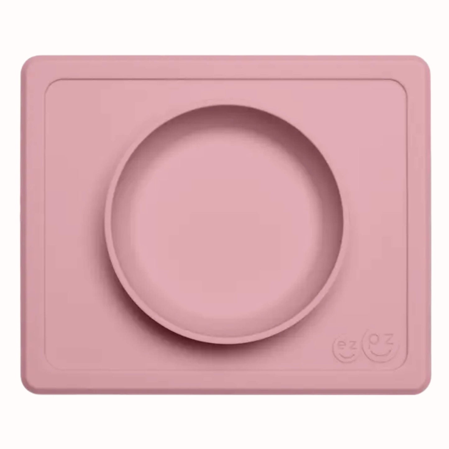 Blush silicone suction bowl with matching rectangular placemat designed for toddler meals and snacks.